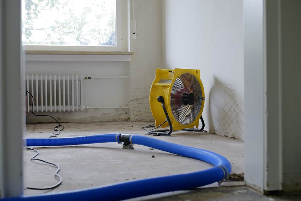 Dehumidifier at work in an apartment which is damaged by flooding