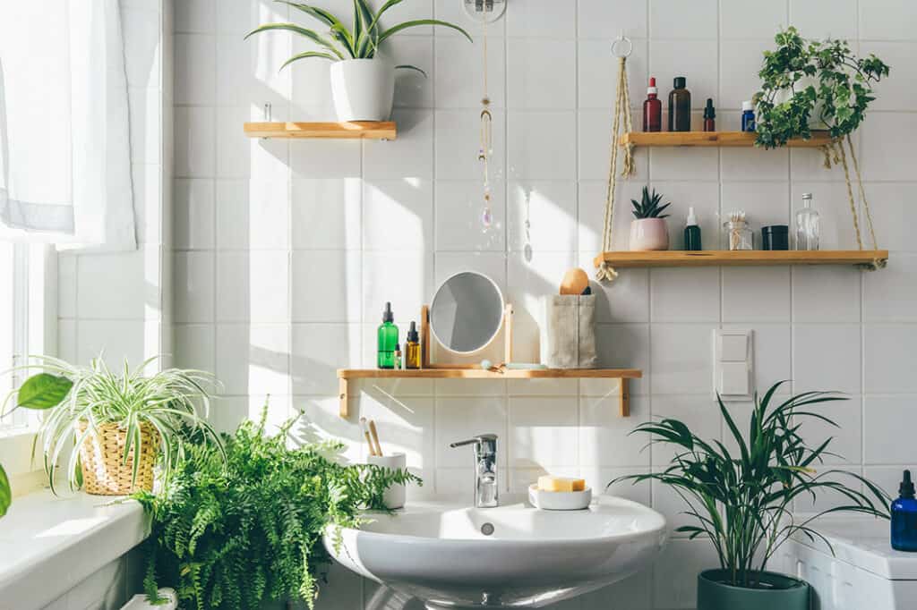 Biophilic design inspired bathroom with plants and wood throughout.