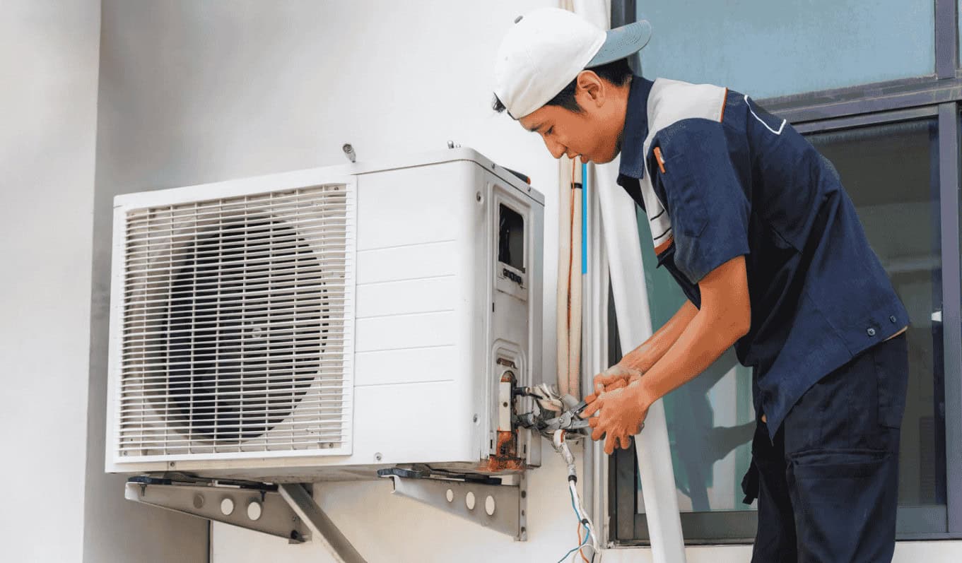 man fixing HVAC filter