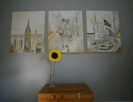 How to Hang Wall Art So It Looks Right (And Stays Put) 57 A sunflower vase on a dresser with wall art