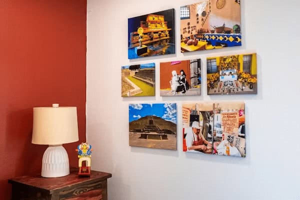 How to Hang Wall Art So It Looks Right (And Stays Put) 1 a wall with a lamp and pictures on it