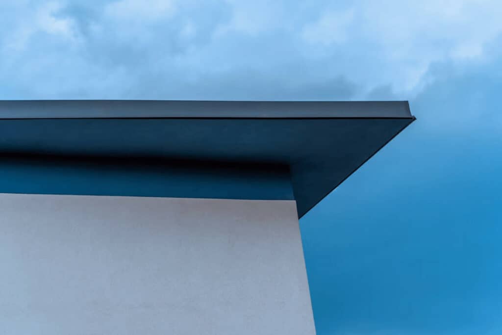 Modern flat roof building against blue sky