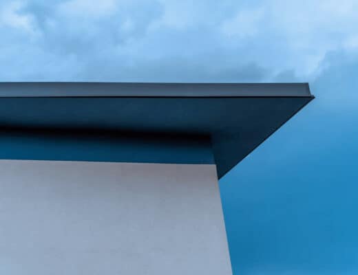 Flat Roof Design Ideas: How to Balance Style, Space, and Performance 4 Modern flat roof building against blue sky