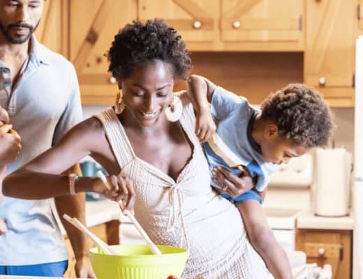 How to Prepare Your Home for A Growing Family 6 Family preparing food together in a kitchen