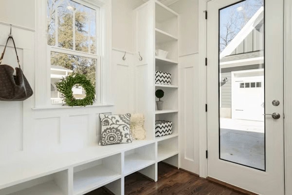 White entryway with bench and mirror, ideal