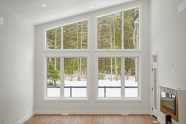 The Growing Focus on Exterior Simplicity in Modern Home Updates 1 an empty room with a large window and a fireplace