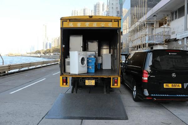 Car parked next to a moving truck for a
