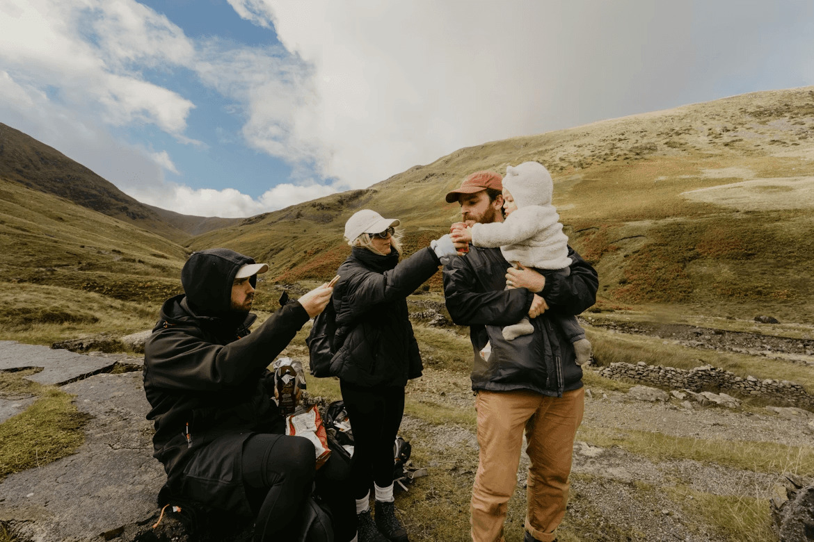 Family enjoying an Iceland road trip view from a green