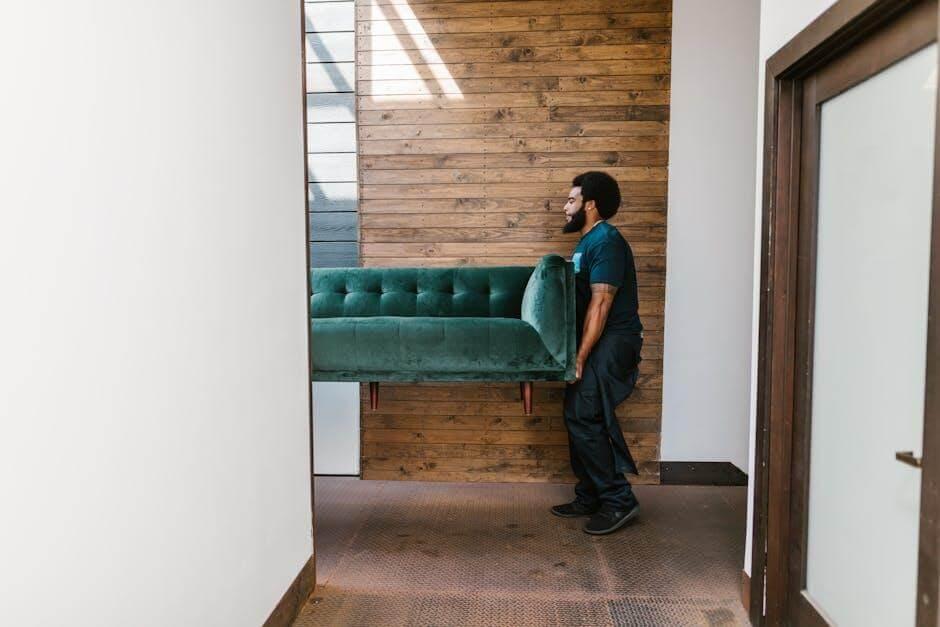 Man standing in a living room with a green couch