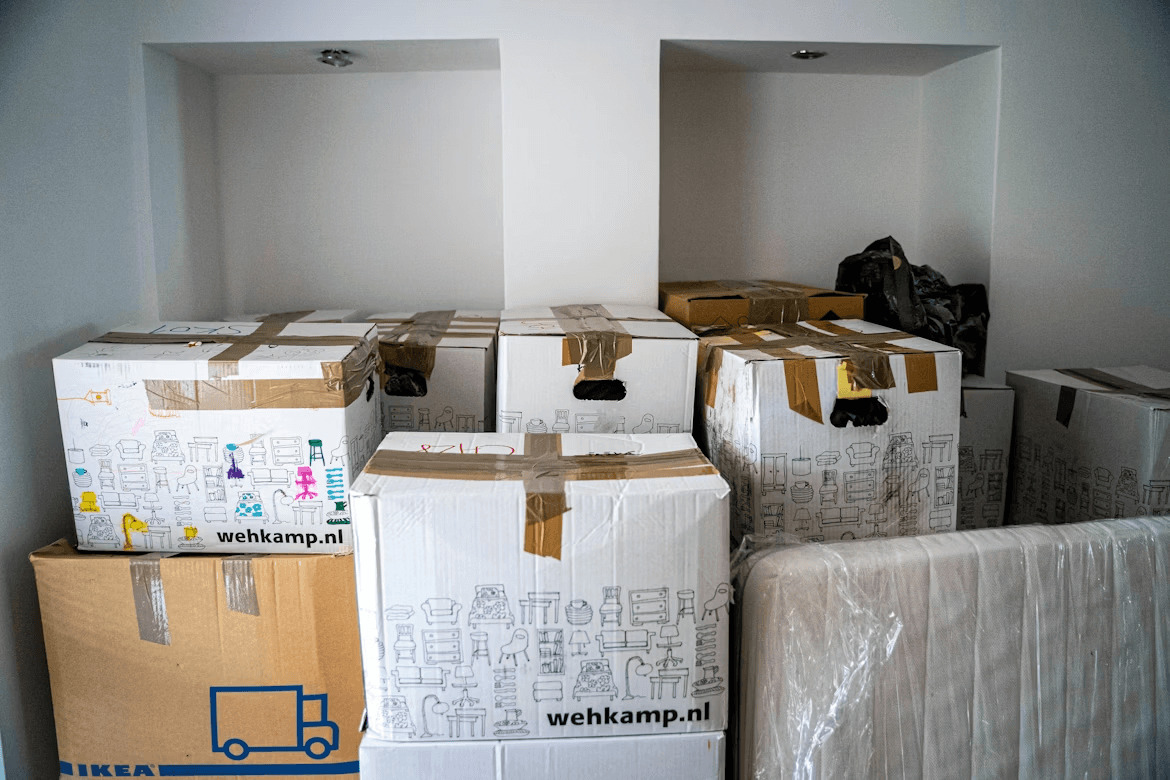 Moving boxes stacked in a room for