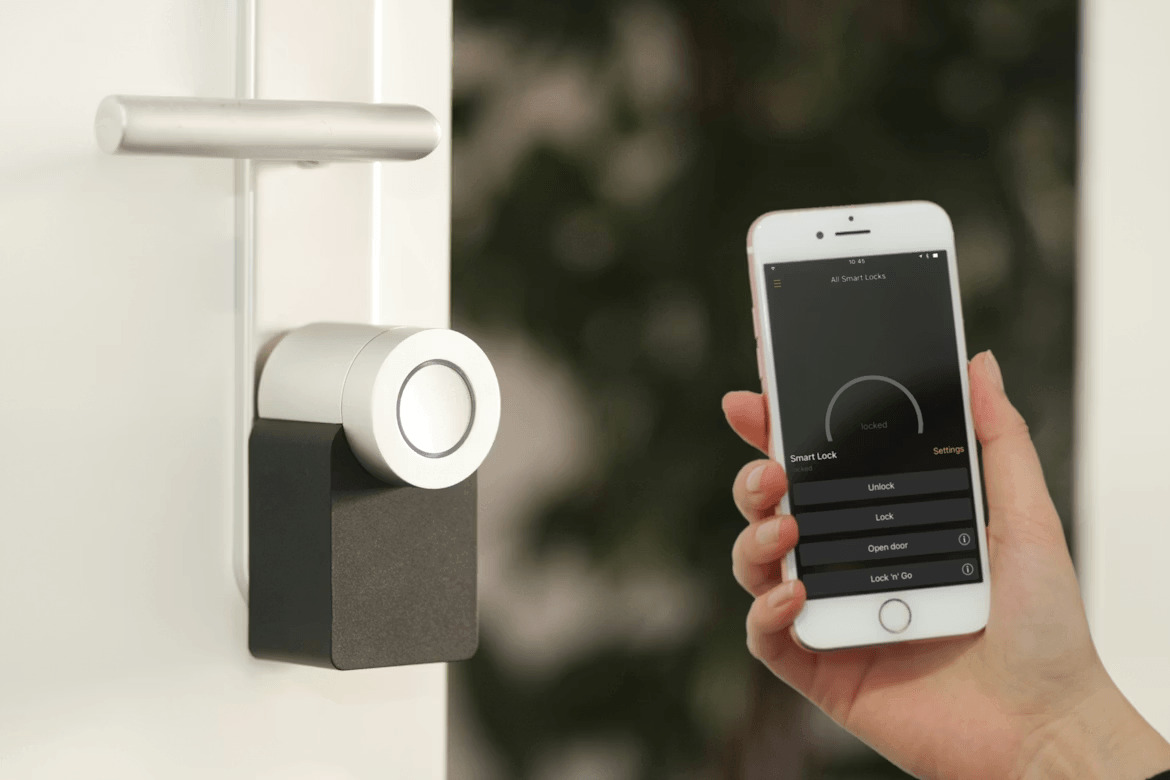Person using smartphone to control smart home security door