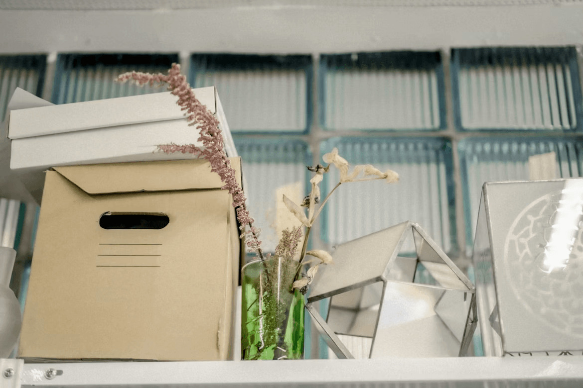 Shelf with vase, boxes, and items