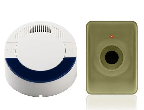 Two differently colored smoke detectors on a wall