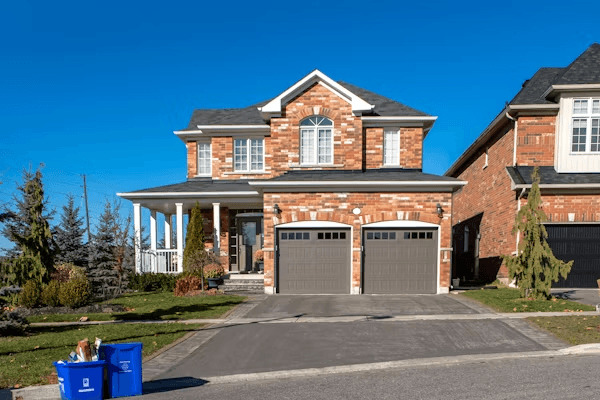 Two-story brick house with two garages, showcasing