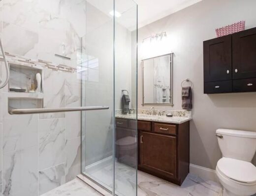 White toilet next to walk-in shower in