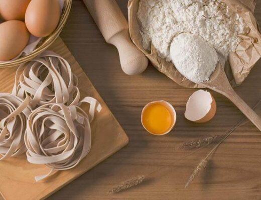 Three Key Ways to Create a Functional and Fresh Kitchen 93 A wooden table with eggs and pasta