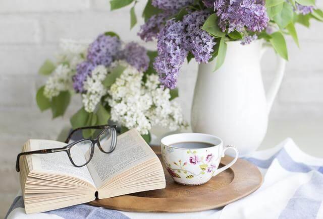 7 New Tea Traditions To Try on International Tea Day 1 Cup with an open book on a plate