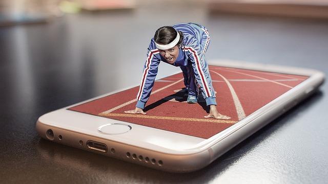 Smart Home, Fit Home: Integrating Wellness Tech Into Your Living Space 1 Man in tracksuit using a phone to control smart home