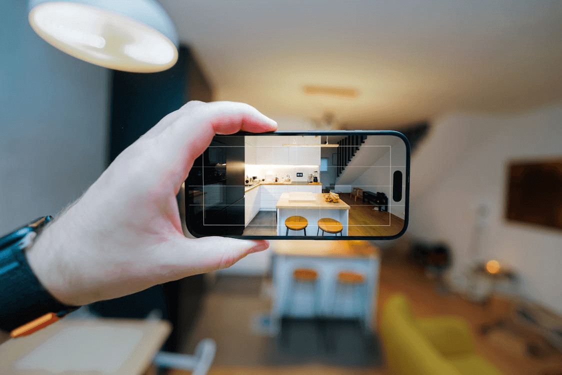 7 Property Management Brands Worth Knowing Before You Choose Your Rental Setup in 2026 1 Person taking a picture of a kitchen for