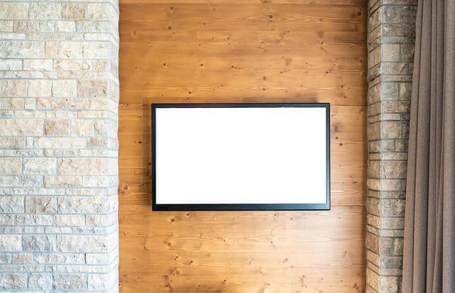 Smart Home, Fit Home: Integrating Wellness Tech Into Your Living Space 2 Smart TV mounted on a brick wall