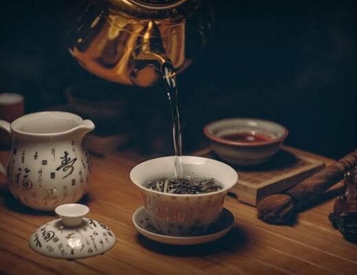 7 New Tea Traditions To Try on International Tea Day 100 Teapot pouring tea into a cup