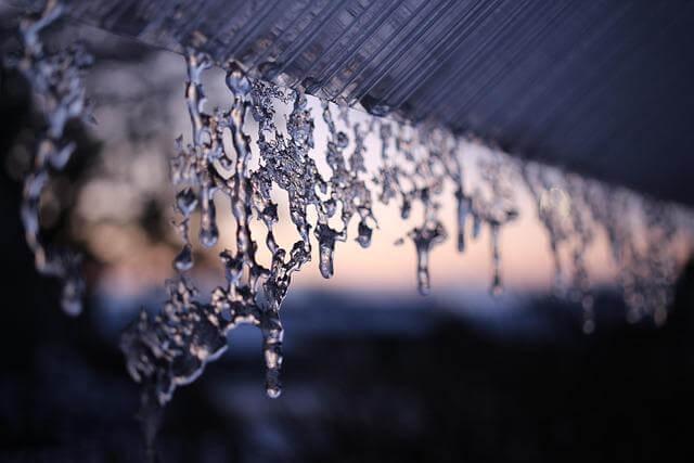Water drops hanging from a roof, indicating a flashing