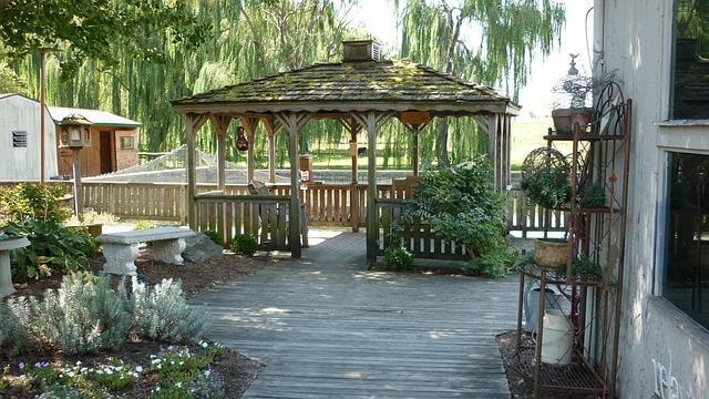 Wooden walkway next to a backyard gazebo