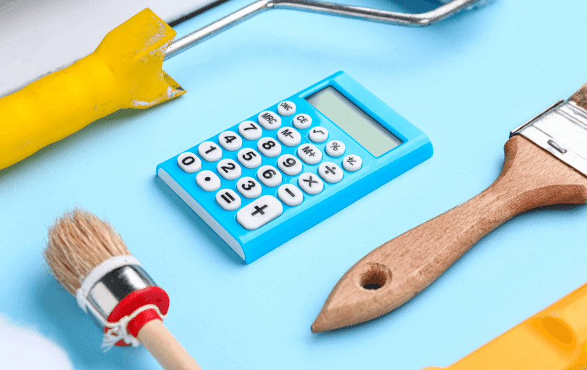 Blue calculator, paintbrush, and paint roller