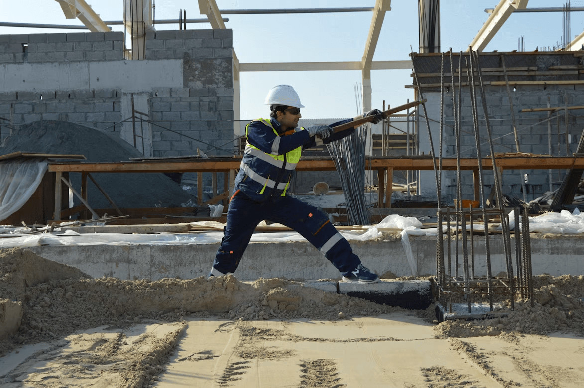 Can You Sue After a Construction Accident? 1 Construction worker with hard hat and overalls holding