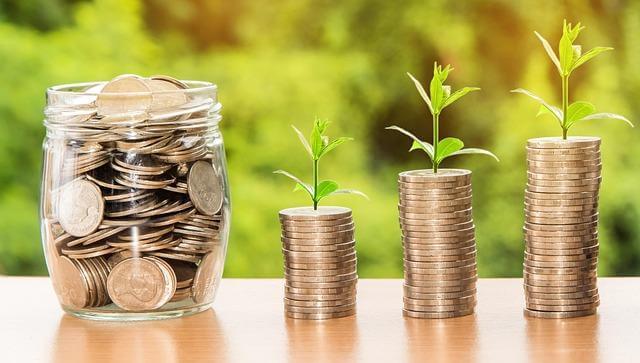 Is Buying an Apartment Actually Better Than Renting? 3 Glass jar with coins and a plant growing, symbolizing