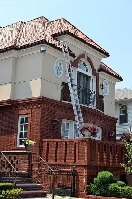 Why Regular Home Inspections Are Essential 1 Ladder attached to a brick home during