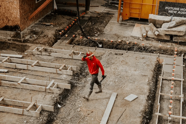 Can You Sue After a Construction Accident? 2 Man in red jacket on a construction site,