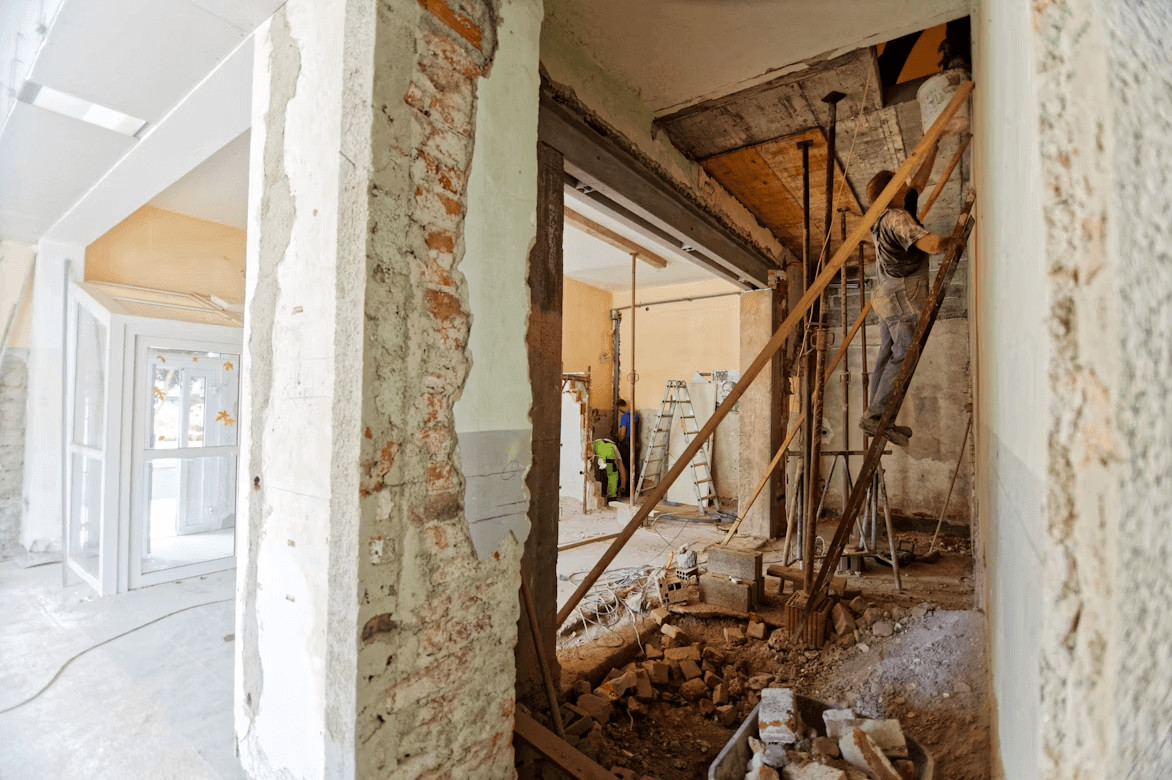 Man surveying a room under construction for renovation