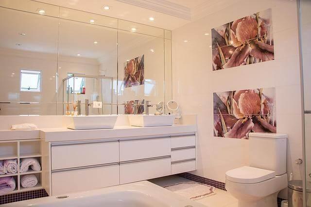 Remodeling for Real Life: Designing a Home That Still Works 10 Years Later 2 Modern bathroom with sink, mirror, toilet