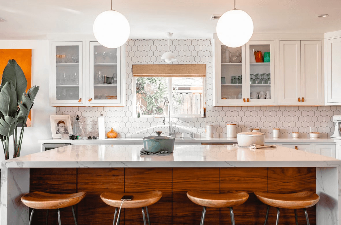 The Away-Home Edit: How to Organize a House You Don’t Use Every Day 1 Modern kitchen with a center island and three stools