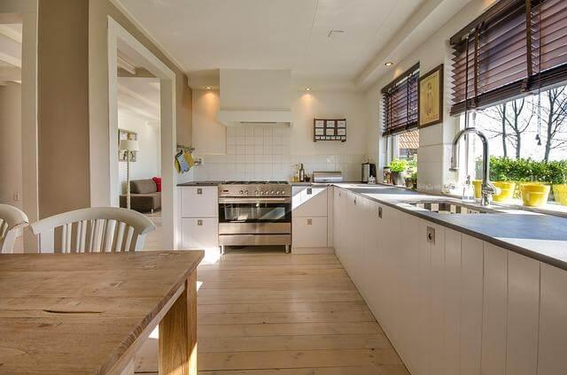 Remodeling for Real Life: Designing a Home That Still Works 10 Years Later 1 Modern kitchen with wooden table and white cabinets