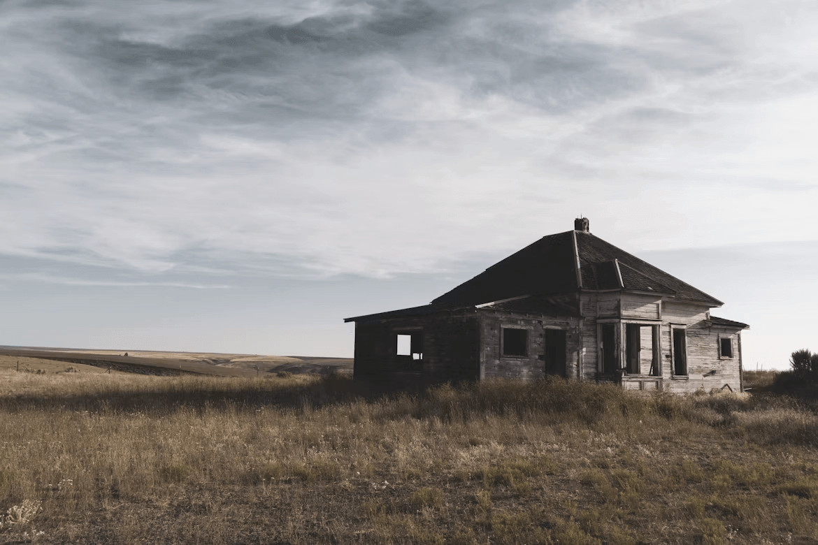 Old run-down house in a field
