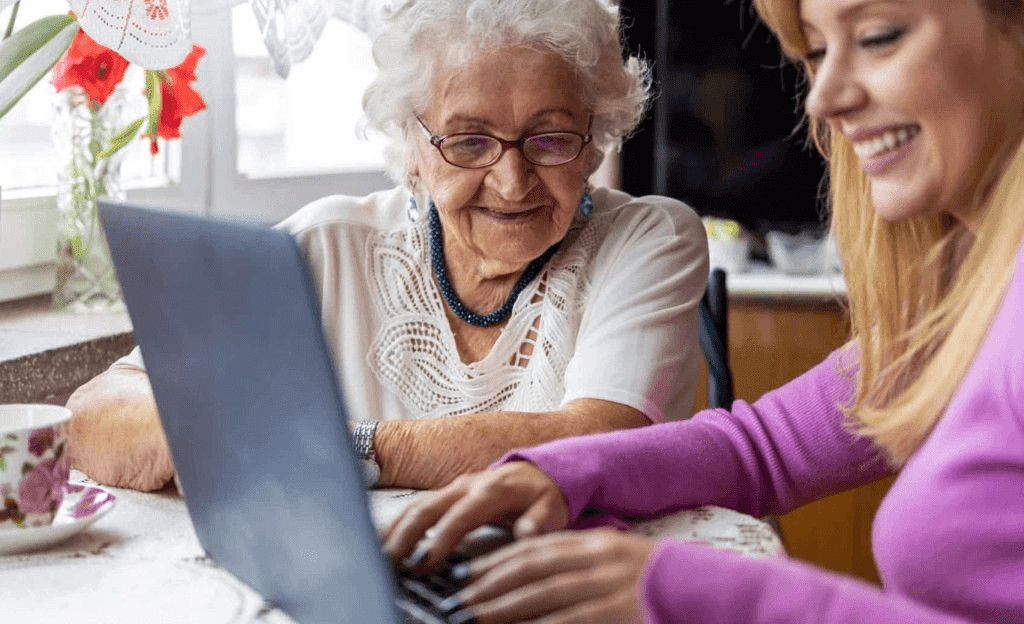 6 Ways Live In Care Reduces Isolation in Older Adults 1 Older woman using a laptop, showing connection