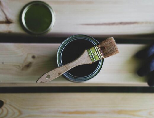 Paint can with a brush resting on top