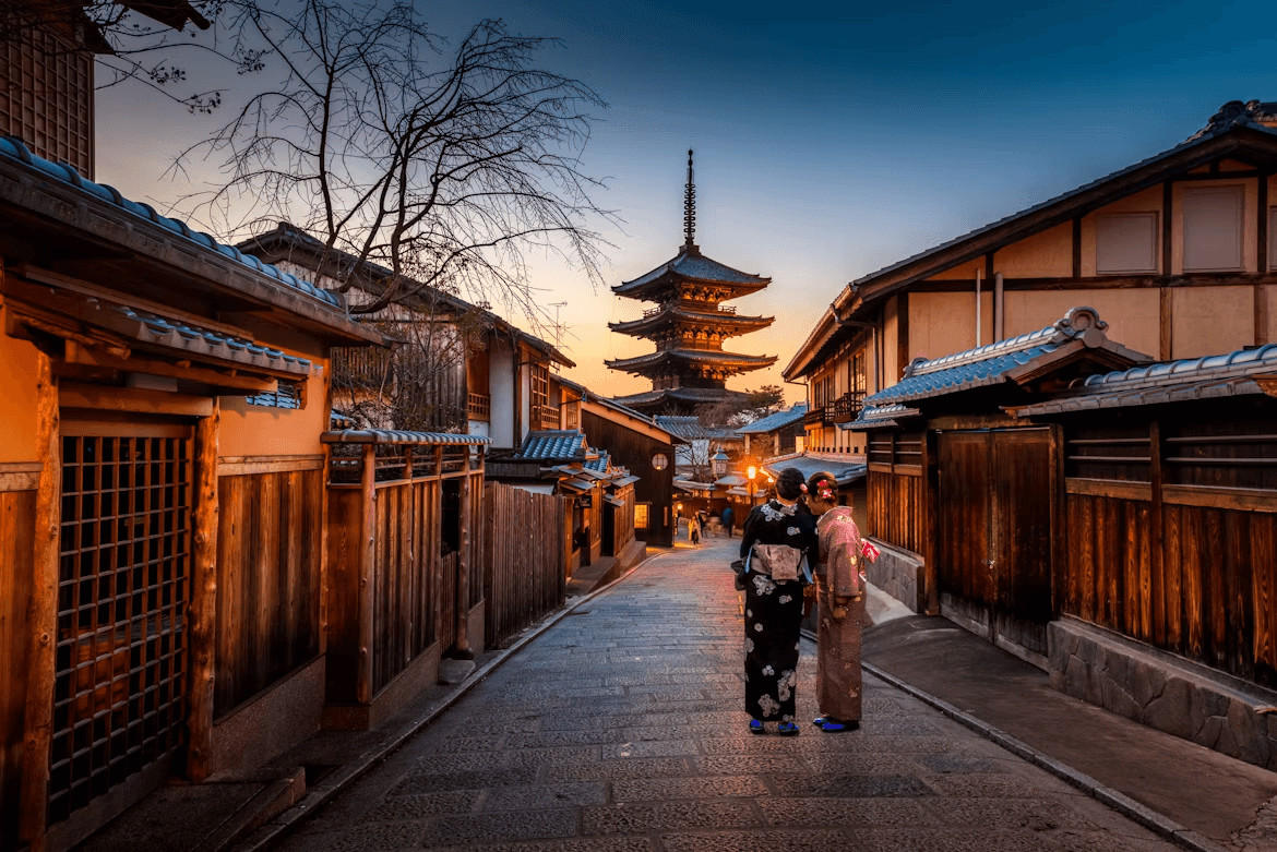 Two women walk down a metropolitan street with