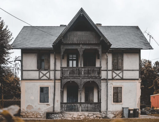 White and black house with gray roof after