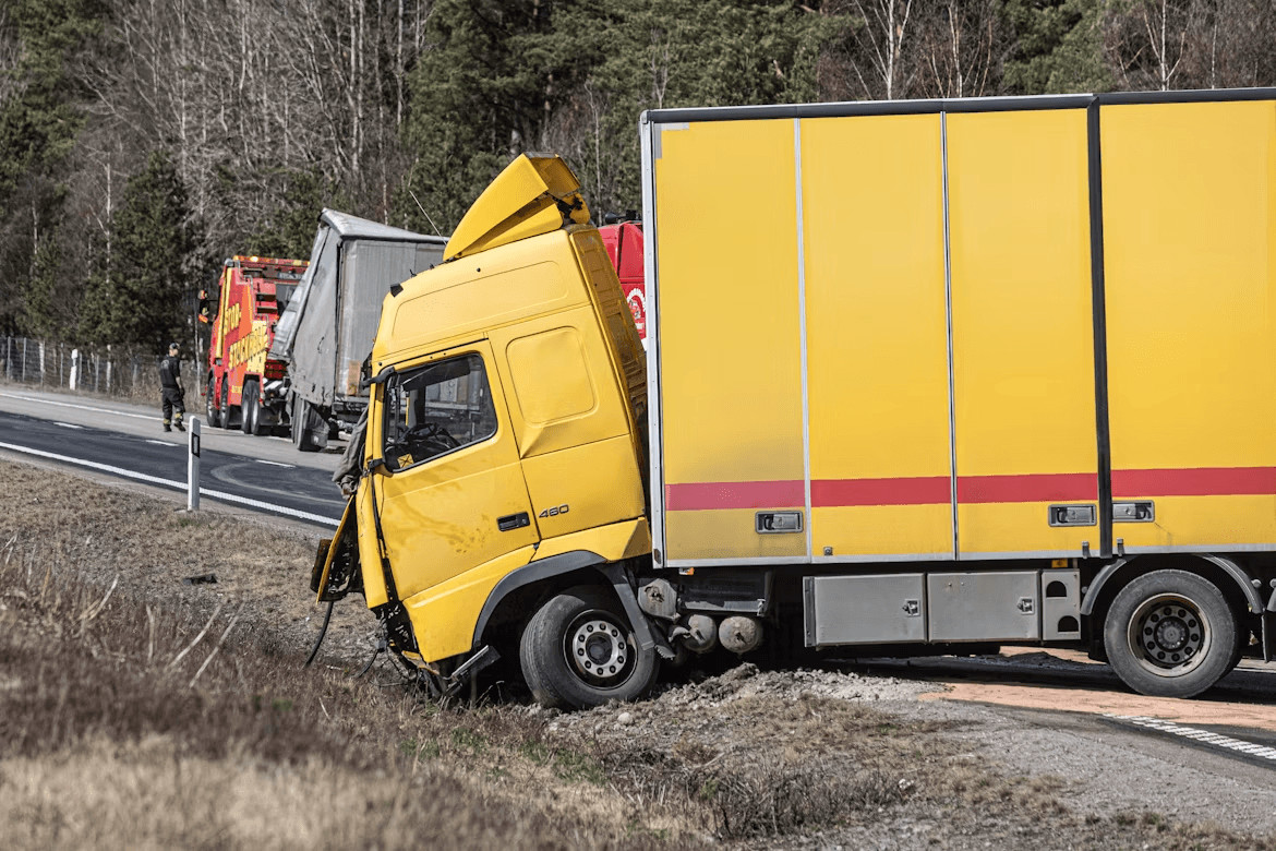 Who Is Liable in a Truck Accident? 1 Yellow truck on side of road related to liability