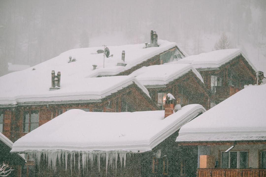 When a DIY Repair List Outgrows Your Skills and Budget 1 A snow-covered house with long icicles hanging from the roof edge in winter