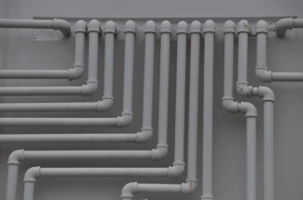 Close-up of sewer pipes on a wall