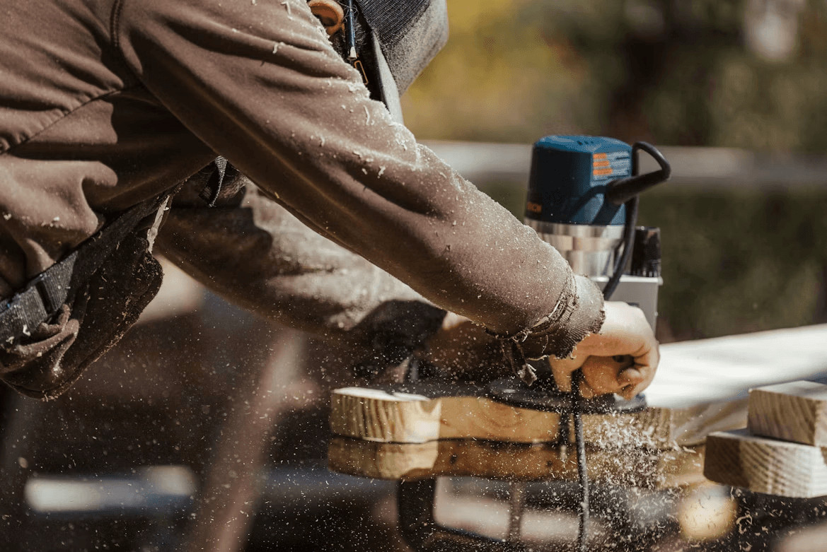 Contractor using a sander on wood