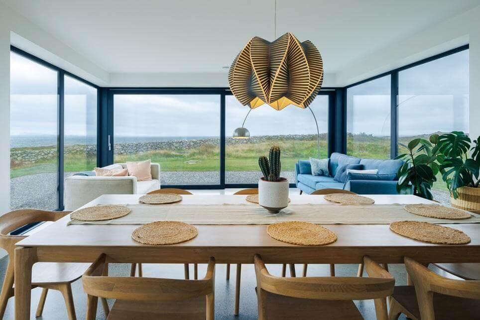 Dining room table with place settings near patio doors