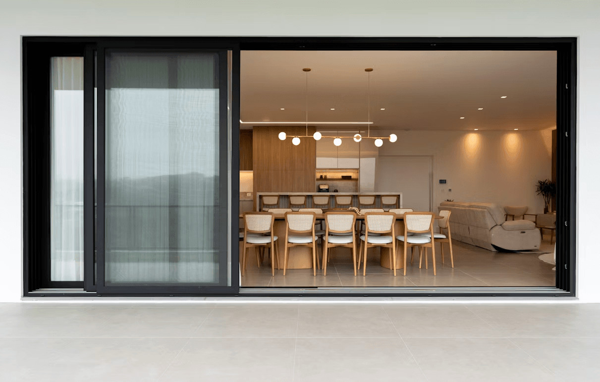 Dining room with table and chairs visible through a sliding