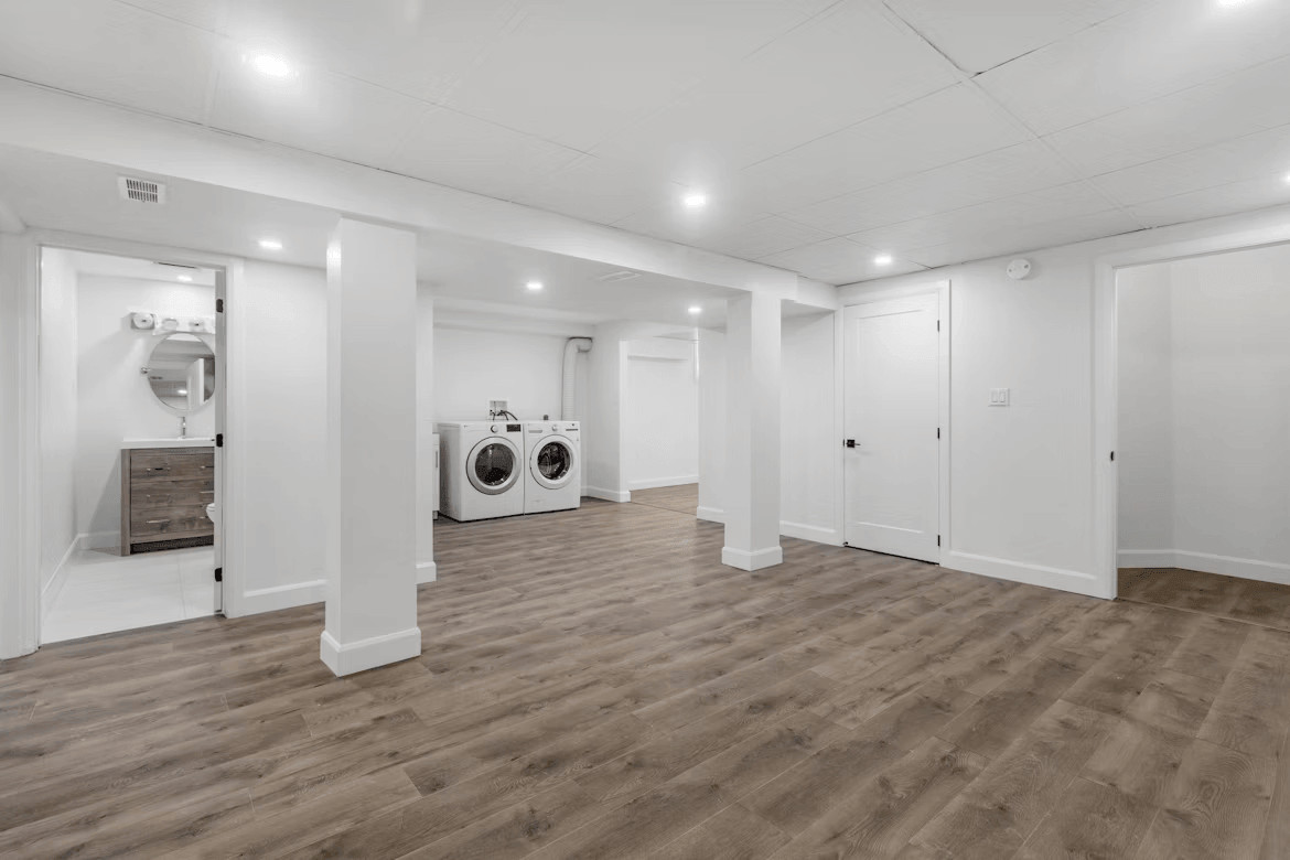 Empty basement laundry room with washer and dryer