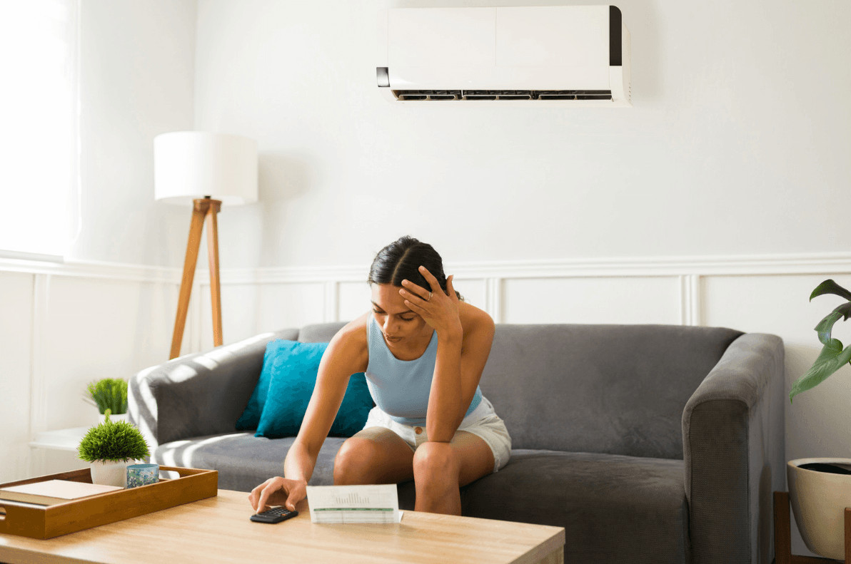 Frustrated woman on couch holding her