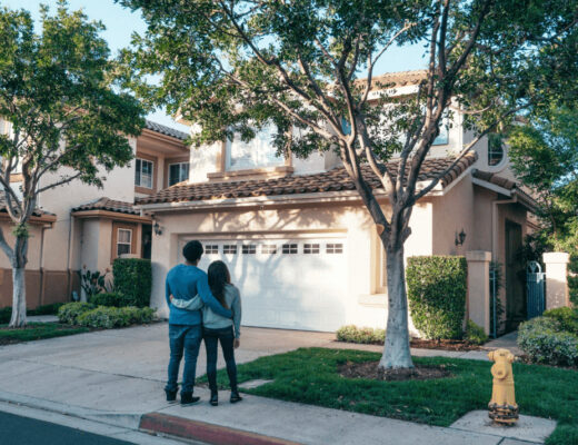 homeowners standing in front of their house